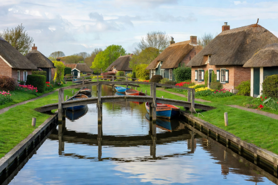 Giethoorn Dutch village canal with wooden bridges and thatched cottages